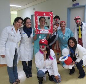 enfermeiros posam para foto; alguns estão maquiados como palhaços