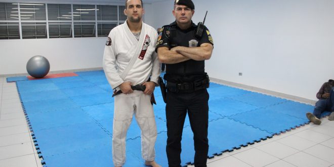 um guarda civil de barueri posa ao lado de um atleta de kimono